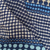 Close-up of Margo Selby wool scarf with blue and yellow polka dots, highlighting its detailed texture and pattern.